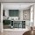 Open plan apartment with green kitchen cabinets and two toned walls